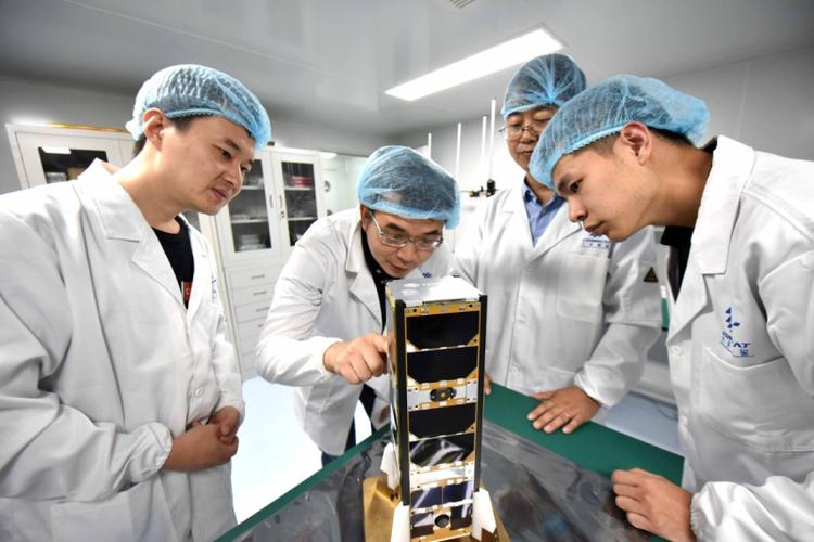 九天微星创始人,首席执行官谢涛(左二)与卫星研发团队探讨卫星技术